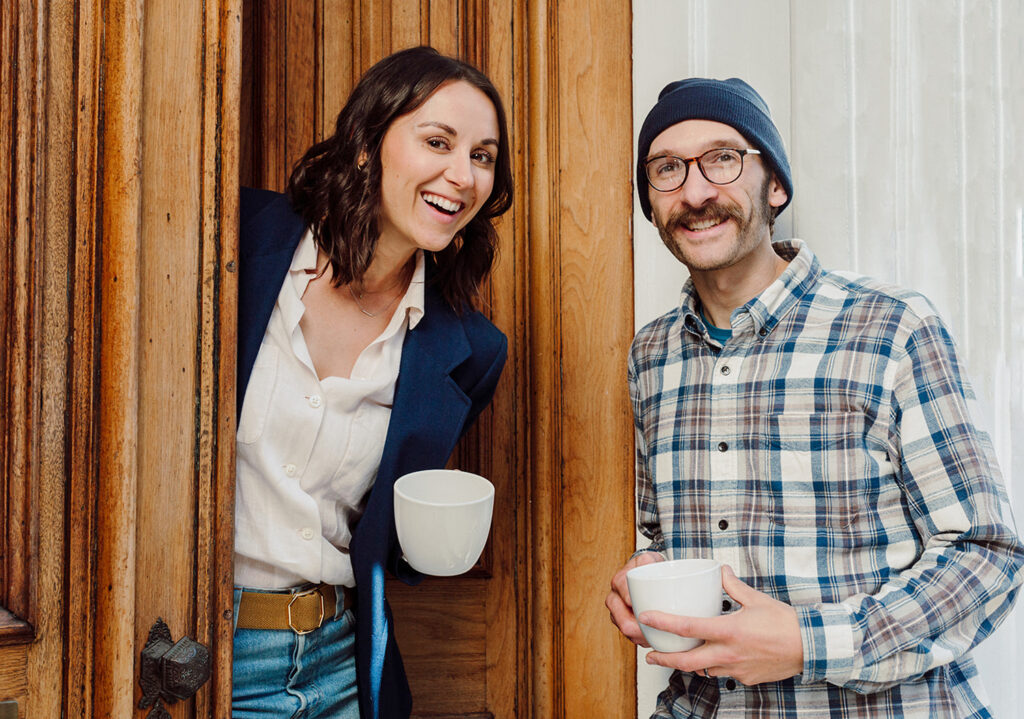 Maggie and Rich holding cups of coffee together.